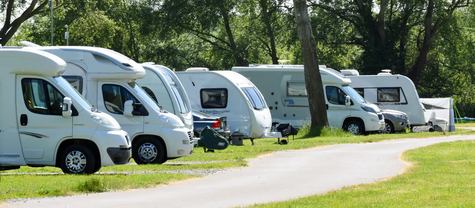 Touring caravans and a motorhome pitched at Chertsey Caravan Park